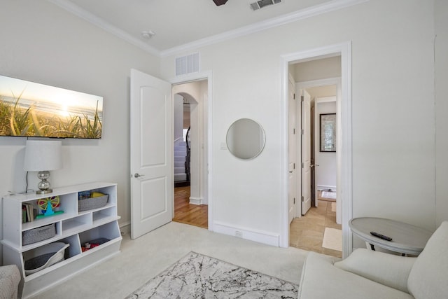 bedroom featuring ornamental molding and light colored carpet