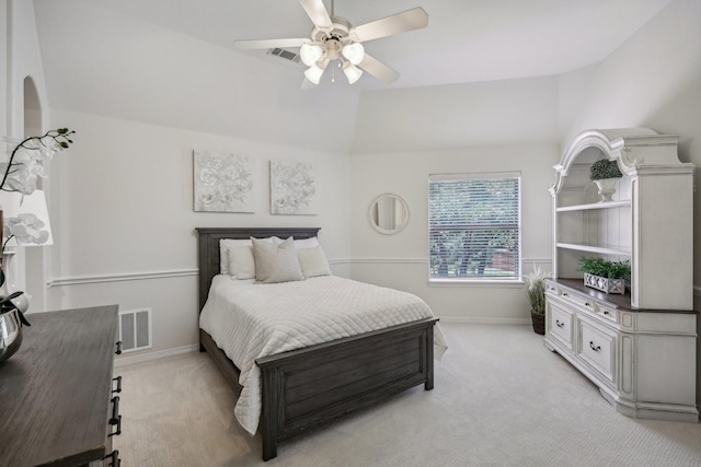 bedroom with vaulted ceiling, light colored carpet, and ceiling fan