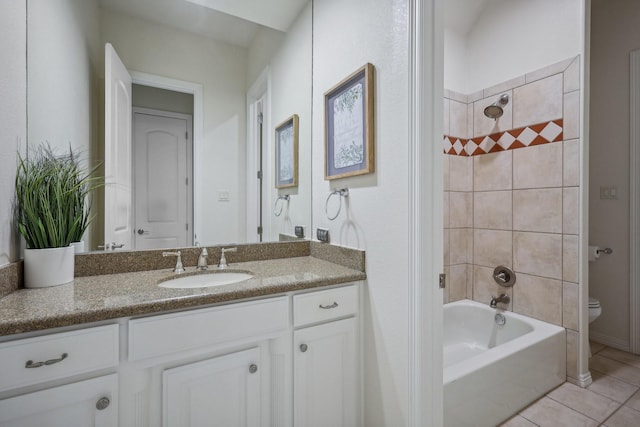 full bathroom featuring vanity, tiled shower / bath combo, tile patterned floors, and toilet