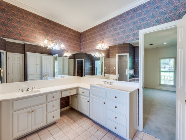 bathroom with ornamental molding, wallpapered walls, and a sink