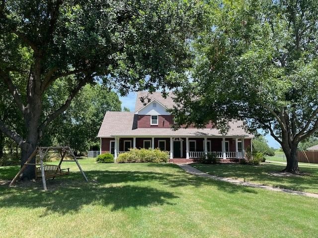 view of front of house featuring a porch, a front yard, and fence