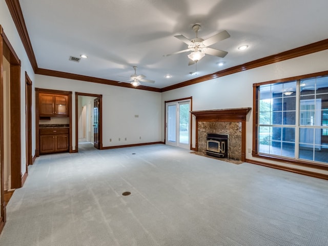 unfurnished living room featuring visible vents, baseboards, recessed lighting, light carpet, and crown molding