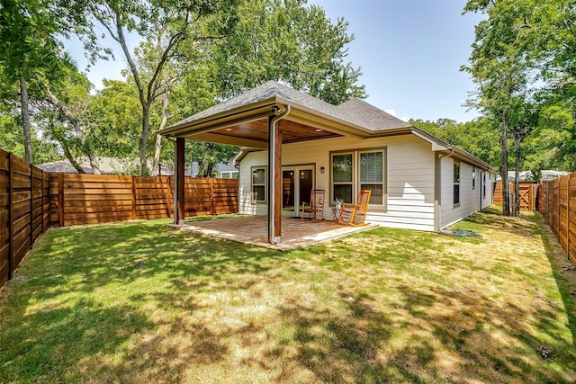 back of property featuring a patio and a yard