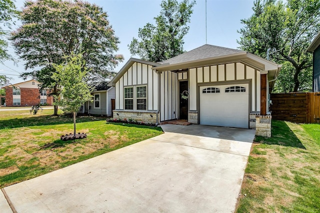 view of front of property with a garage and a front lawn