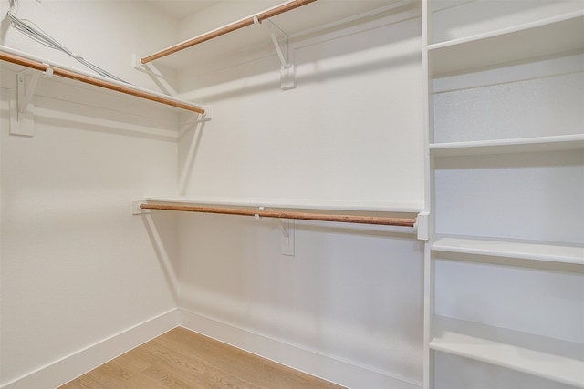 spacious closet with light hardwood / wood-style flooring