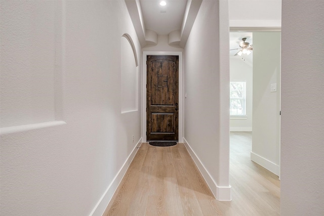 corridor with light wood-type flooring