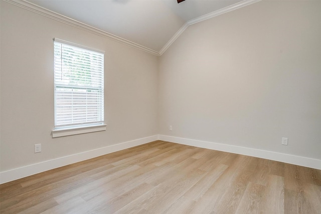 spare room featuring lofted ceiling, ornamental molding, and light hardwood / wood-style flooring