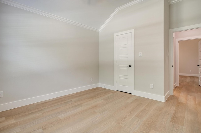 unfurnished room with vaulted ceiling, light hardwood / wood-style flooring, and ornamental molding