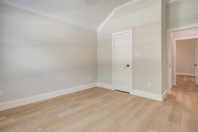 spare room with crown molding, high vaulted ceiling, and light hardwood / wood-style flooring