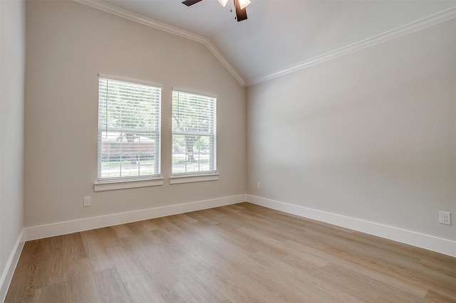 spare room with vaulted ceiling, ceiling fan, crown molding, and light hardwood / wood-style flooring