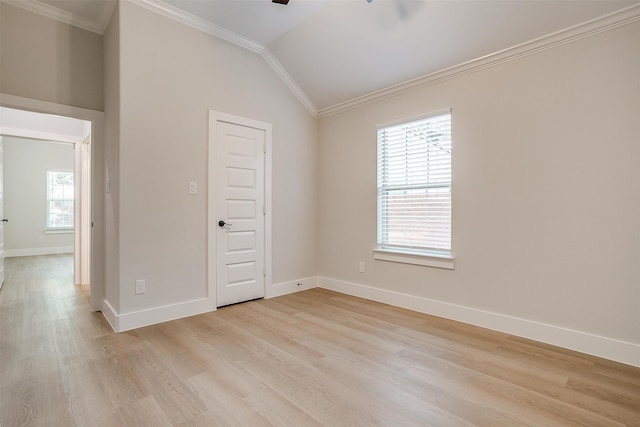 spare room with ceiling fan, light hardwood / wood-style floors, vaulted ceiling, and ornamental molding