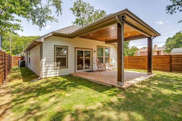 rear view of property with a patio and a yard