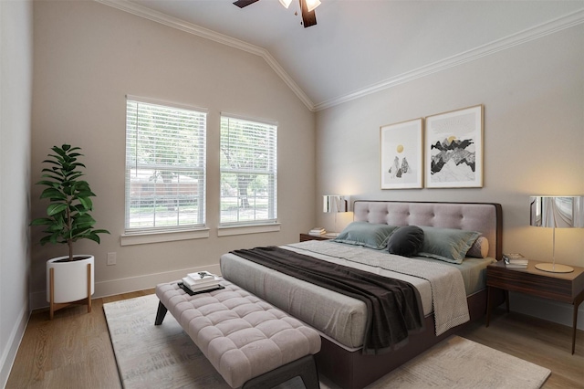 bedroom featuring lofted ceiling, crown molding, wood-type flooring, and ceiling fan