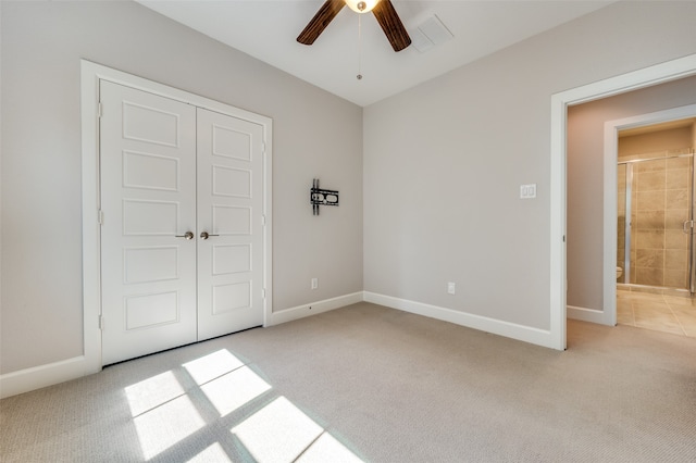 unfurnished bedroom featuring ceiling fan, light colored carpet, and a closet