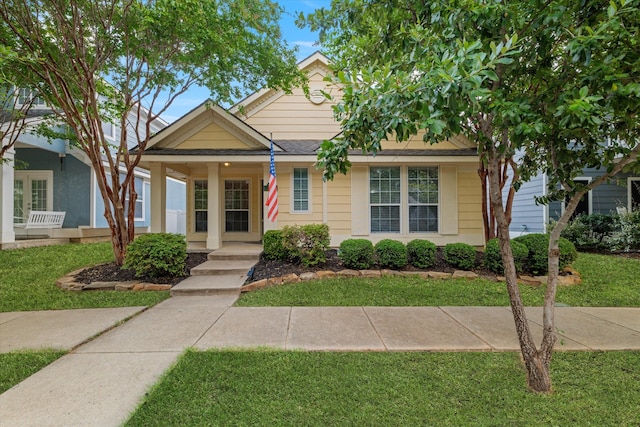 bungalow-style home with a porch and a front yard