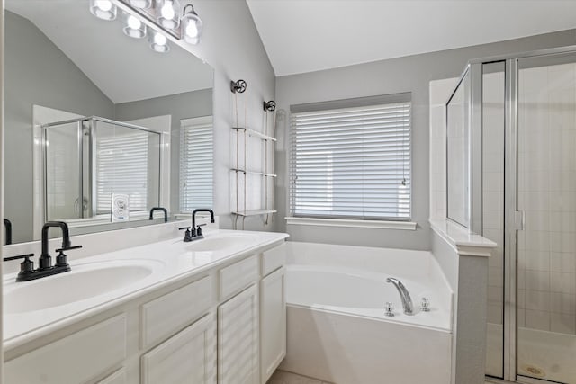 bathroom featuring lofted ceiling, double sink vanity, and plus walk in shower