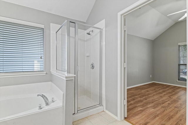 bathroom with hardwood / wood-style floors, ceiling fan, vaulted ceiling, and separate shower and tub