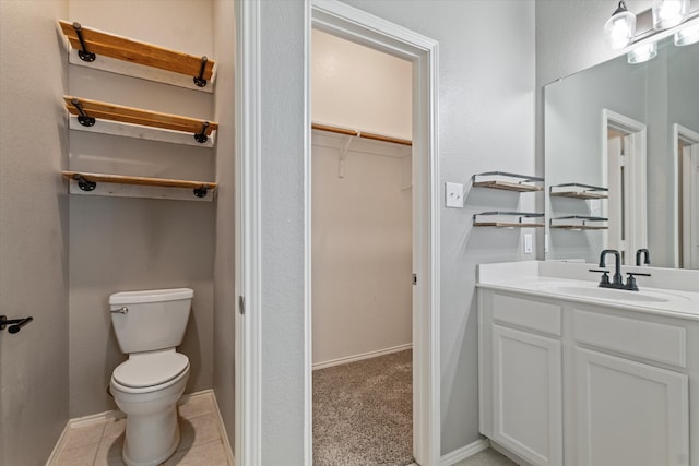 bathroom with vanity, tile patterned flooring, and toilet