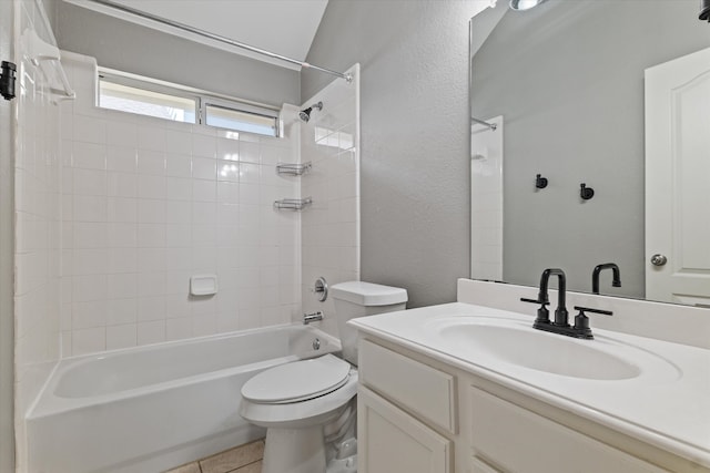 full bathroom featuring vanity, toilet, tiled shower / bath, and tile patterned flooring