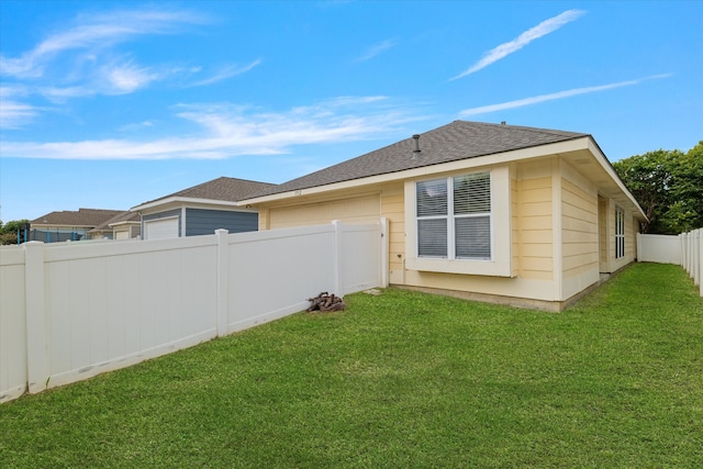 rear view of property featuring a yard