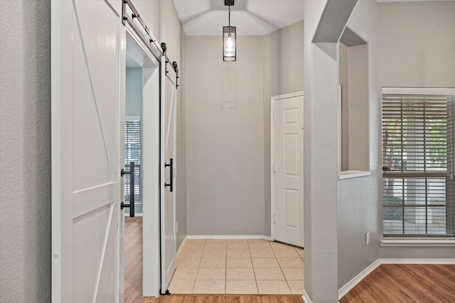 foyer with light hardwood / wood-style flooring and a barn door