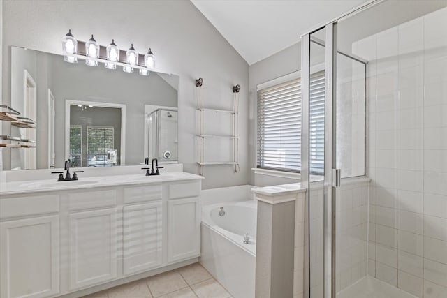 bathroom featuring vaulted ceiling, tile patterned floors, independent shower and bath, and dual bowl vanity