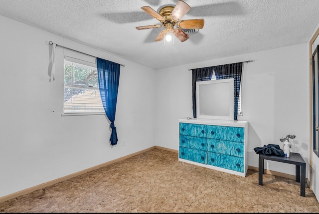 interior space featuring light carpet, a textured ceiling, and ceiling fan