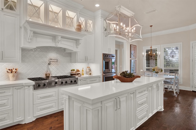 kitchen featuring dark hardwood / wood-style floors, crown molding, backsplash, and stainless steel appliances