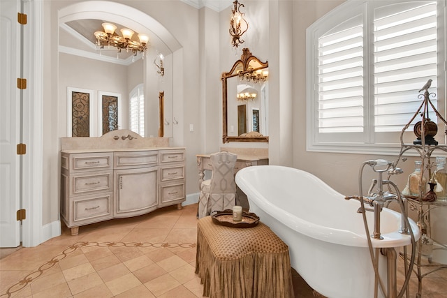 bathroom with a notable chandelier, tile patterned floors, a bath, and ornamental molding