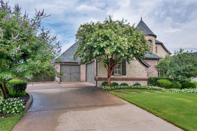 view of front of property with a garage and a front yard