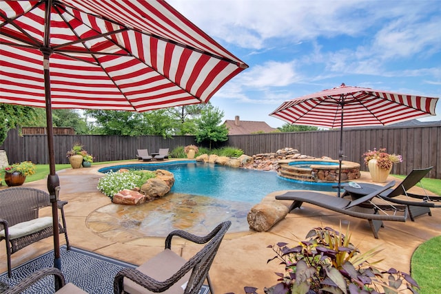 view of swimming pool featuring an in ground hot tub and a patio area