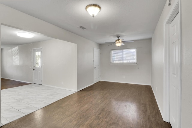 unfurnished room with ceiling fan, a wealth of natural light, and light hardwood / wood-style flooring