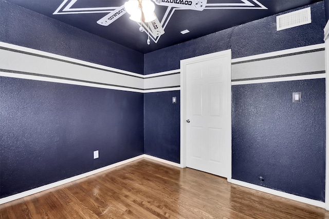 spare room with ceiling fan and wood-type flooring