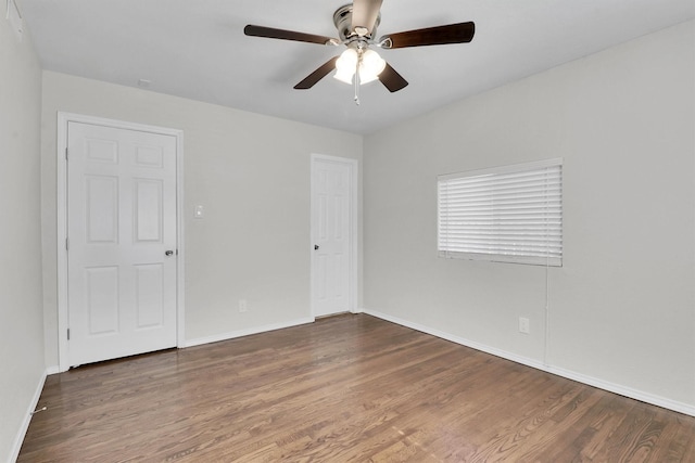 unfurnished room featuring dark hardwood / wood-style floors and ceiling fan