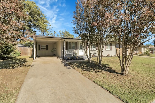 view of front of home with a front lawn and a carport