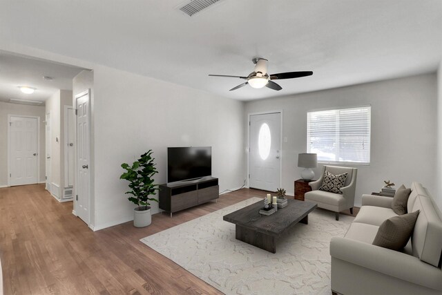 living room featuring hardwood / wood-style flooring and ceiling fan