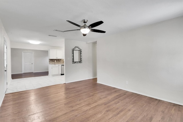 unfurnished living room featuring light hardwood / wood-style floors and ceiling fan