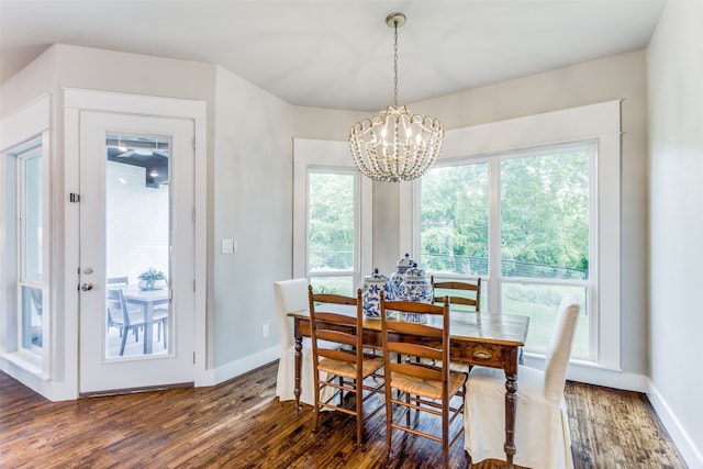 dining space featuring a chandelier and dark hardwood / wood-style flooring