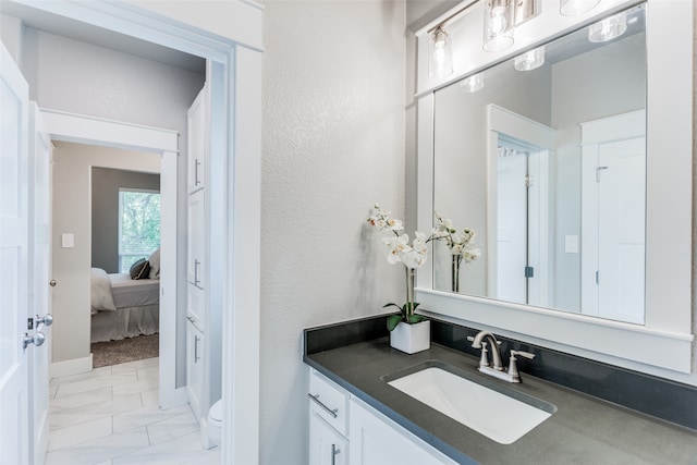 bathroom featuring vanity, toilet, and tile patterned floors