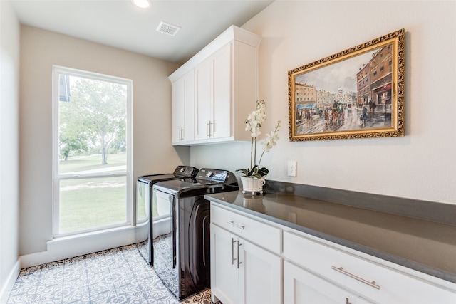 laundry room featuring cabinets, light tile patterned flooring, and independent washer and dryer