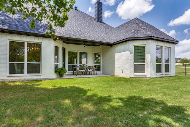 back of property featuring a patio, a lawn, and ceiling fan