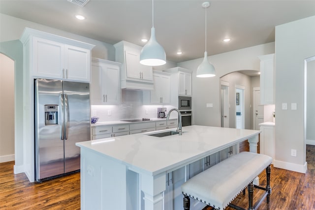 kitchen with decorative backsplash, dark hardwood / wood-style flooring, stainless steel appliances, and white cabinetry