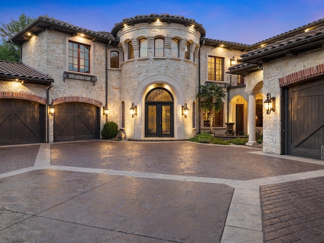 2115 Paradise Ranch Trl, Mckinney, TX 75071 - mediterranean / spanish-style home with decorative driveway, stone siding, a tiled roof, and french doors
