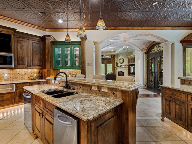 2115 Paradise Ranch Trl, Mckinney, TX 75071 - kitchen with built in microwave, arched walkways, a sink, an ornate ceiling, and ornate columns