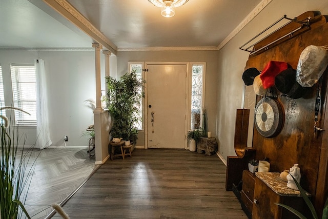 foyer featuring plenty of natural light, decorative columns, crown molding, and dark parquet floors