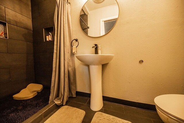 bathroom featuring tile patterned floors and toilet