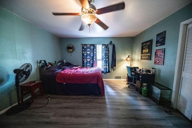 bedroom with hardwood / wood-style flooring and ceiling fan