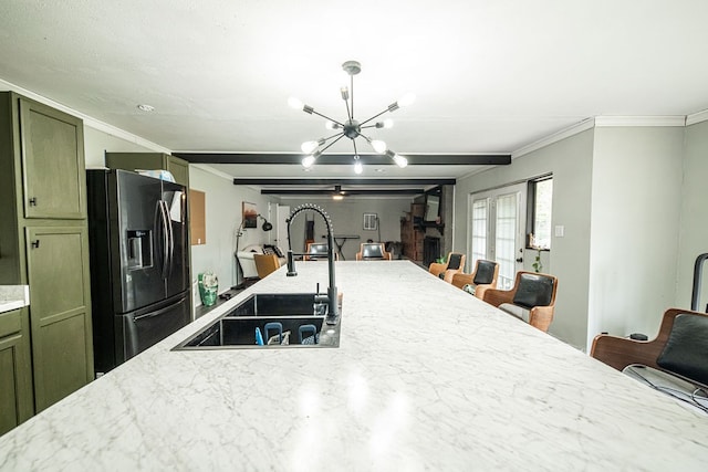 kitchen featuring black fridge, sink, an inviting chandelier, french doors, and a breakfast bar area