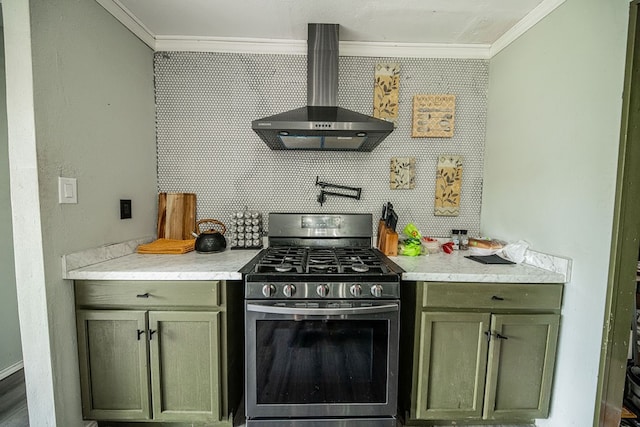 kitchen with ornamental molding, stainless steel gas range, and wall chimney range hood