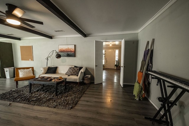 living room featuring beamed ceiling, dark hardwood / wood-style floors, ceiling fan, and ornamental molding